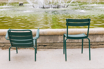Two traditional green chairs with no people in the Tuileries Garden, Paris, France
