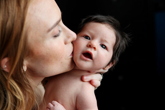 Bare Chested Mother Looking At Baby