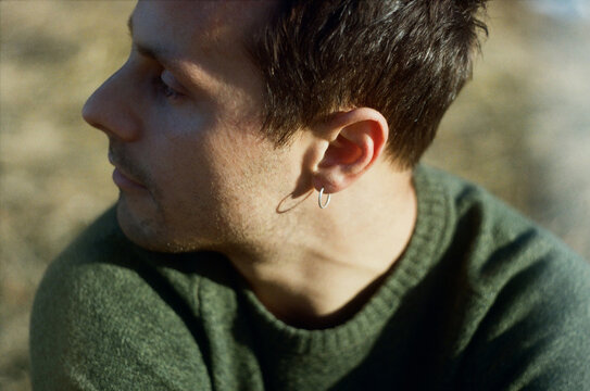 Close-Up of a Pensive Man Outdoors at Dusk