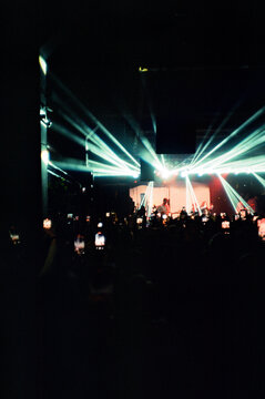 Night club with glowing lights during artist performance on stage