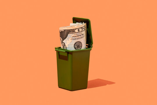 dollars in a trash can