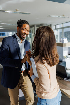 Cheerful entrepreneurs giving high-five in office