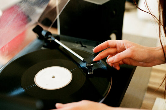 Woman putting on a vinyl record 
