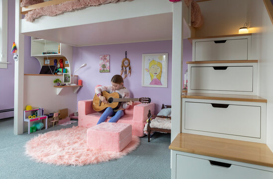 Young girl Bedroom  interior with girl playing guitar Portrait
