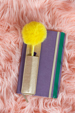 Journal diary book still life on pink fuzzy rug 