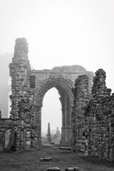 Ancient stone ruins in foggy weather in Tynemouth Priory and Castle