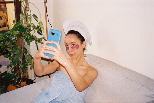 Film picture of woman with towels taking a selfie