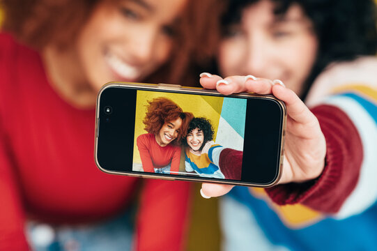 Young girls capturing memories with a smartphone