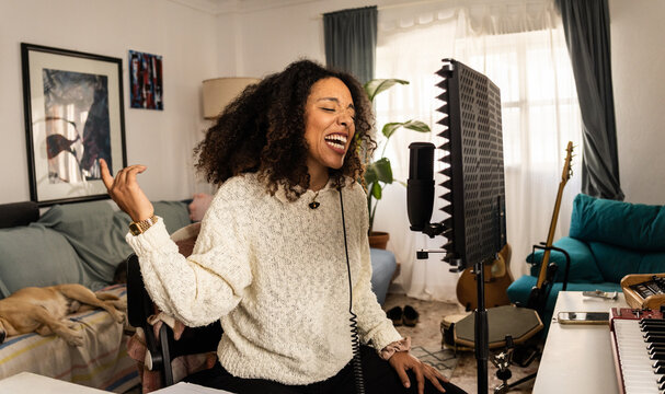 Woman performing vocals, recording studio
