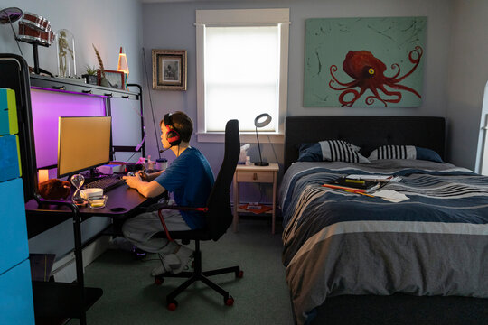 Young Boys Portrait Gamer on Computer home bedroom headphones