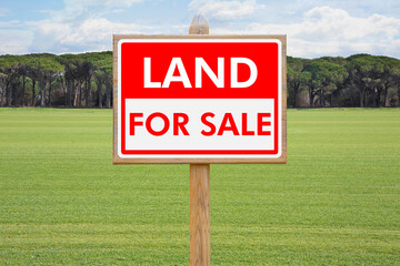 Land For Sale - Real estate concept with a vacant lot for sale available for building construction - Land plot managemen twith an advertising billboard in a rural scene