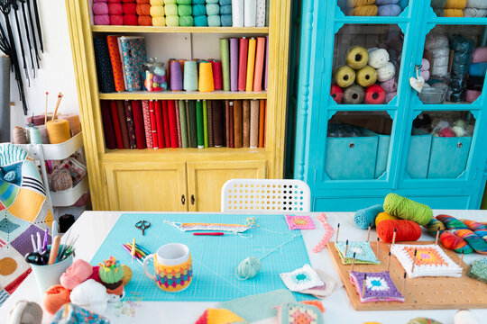 Colorful craft room filled with yarns and fabrics - Powered by Adobe