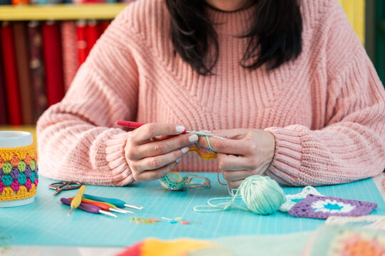 Woman crafting colorful crochet patterns
