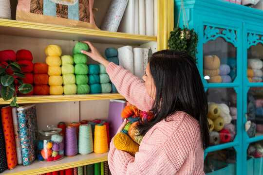 Woman shopping for yarn at craft store