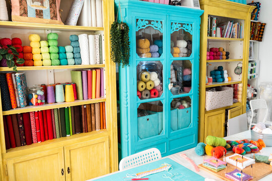Colorful craft room with fabric and yarn storage