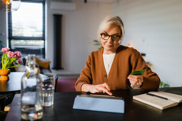 A woman shops online on a tablet