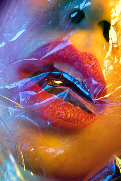 Passionate red lips closeup in vivid coloured light