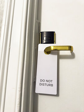 Do Not Disturb sign on door at Motel room travel images 