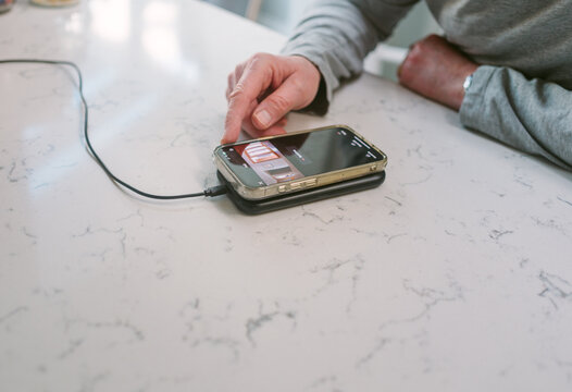 Man looking at the live feed of his home security cameras on his phone