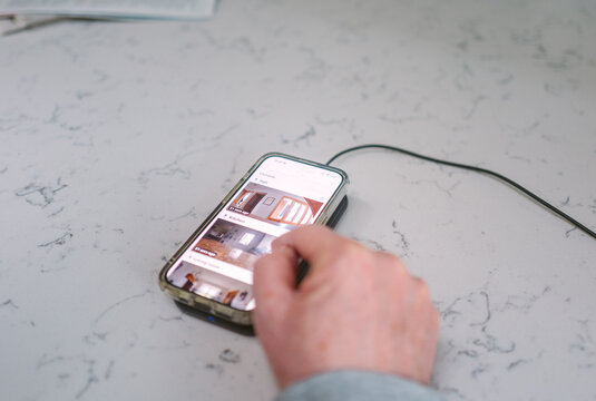 Man looking at the live feed of his home security cameras on his phone
