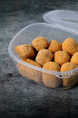 Plastic container with croquettes for frying