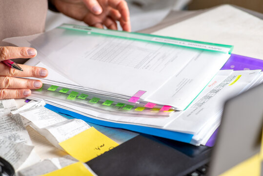 Anonymous hands of an accountant working with documents