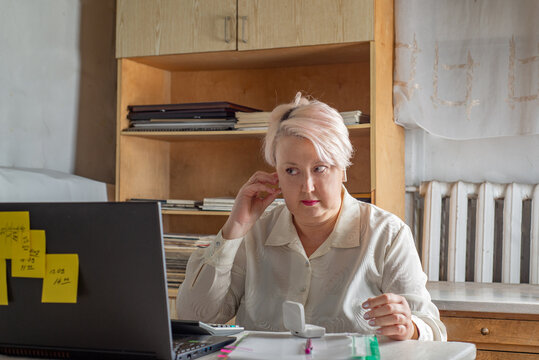 Portrait of a female accountant with wireless headphones in the office