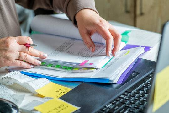 Anonymous hands of an accountant working with documents