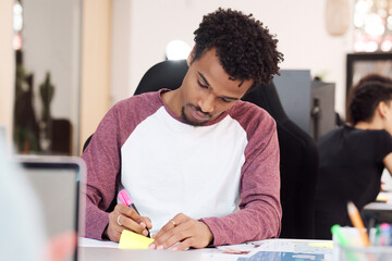 Man Focused on Writing Notes