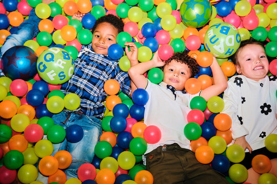 Multiethnic group of Latino kids in a ball pool