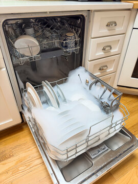 Dishwasher in kitchen overflow with suds 