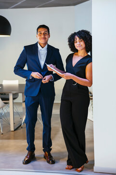 Confident lawyers standing on modern office
