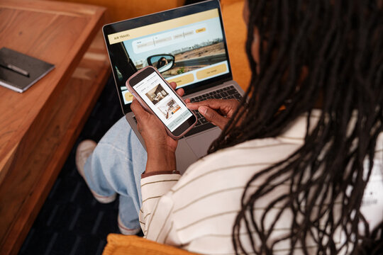 Woman planning vacation trip with laptop and smartphone