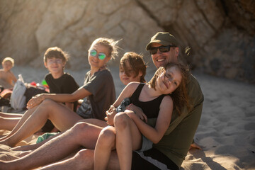 family relaxing on the beach