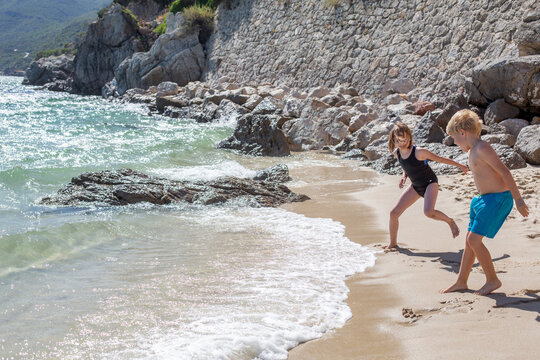 happy children playing on the beach 