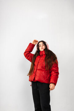 Energetic preteen in Red Puffer Jacket Enjoying Music