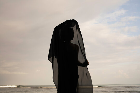 Abstract female dance on beach in sunrise