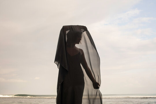 Abstract female dance on beach in sunrise