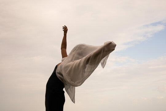Abstract female dance on beach in sunrise
