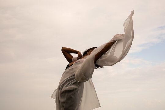 Abstract female dance on beach in sunrise