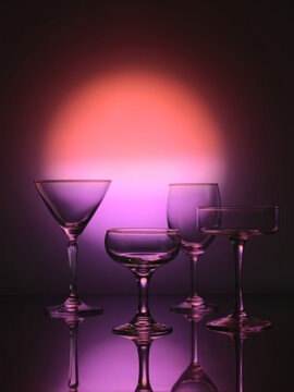 Four glass goblets on a colored gradient background