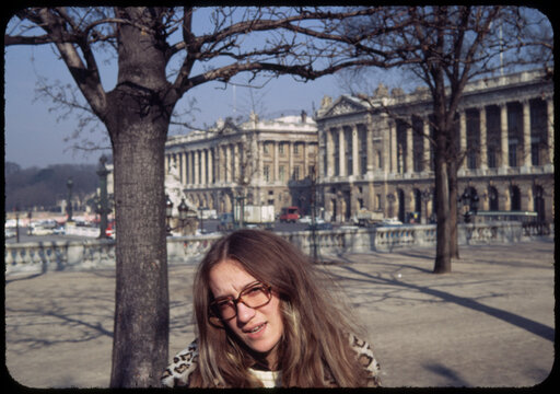 70's Old analog photo. Young woman in front of Versailles Palace 
