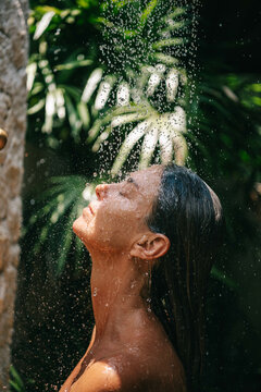 Woman taking a shower outdoors