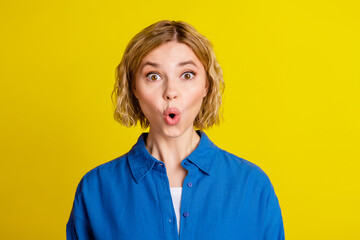 Portrait of pretty young lady pouted lips wear blue shirt isolated on yellow color background