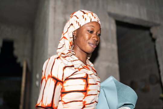 Senegalese Woman in Traditional Attire at Home