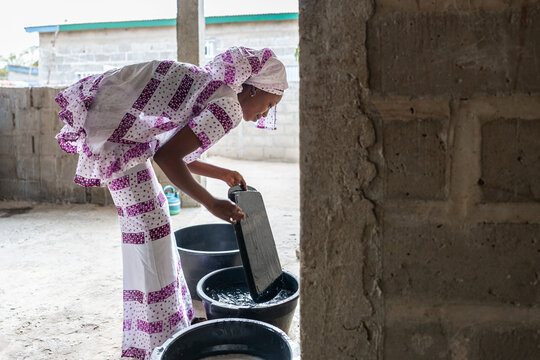 Senegalese Woman Washing Dishes