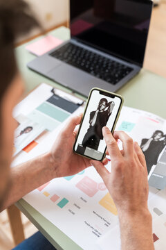 man Reviewing Fashion on Smartphone