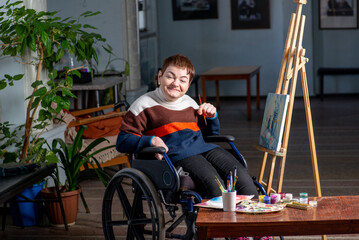 Artist in a wheelchair paints a picture