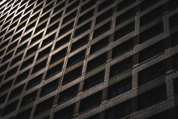 Fototapeta premium Close-up of a fragment of a multi-storey high-rise residential building. apartments and office space. Background for a banner for the sale and rent of real estate.