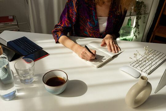 back view of woman sitting at desk